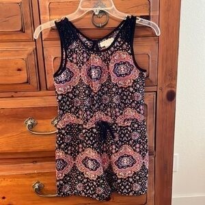 Zoe & Rose band of gypsies Girl’s black, rust and purple colored romper.